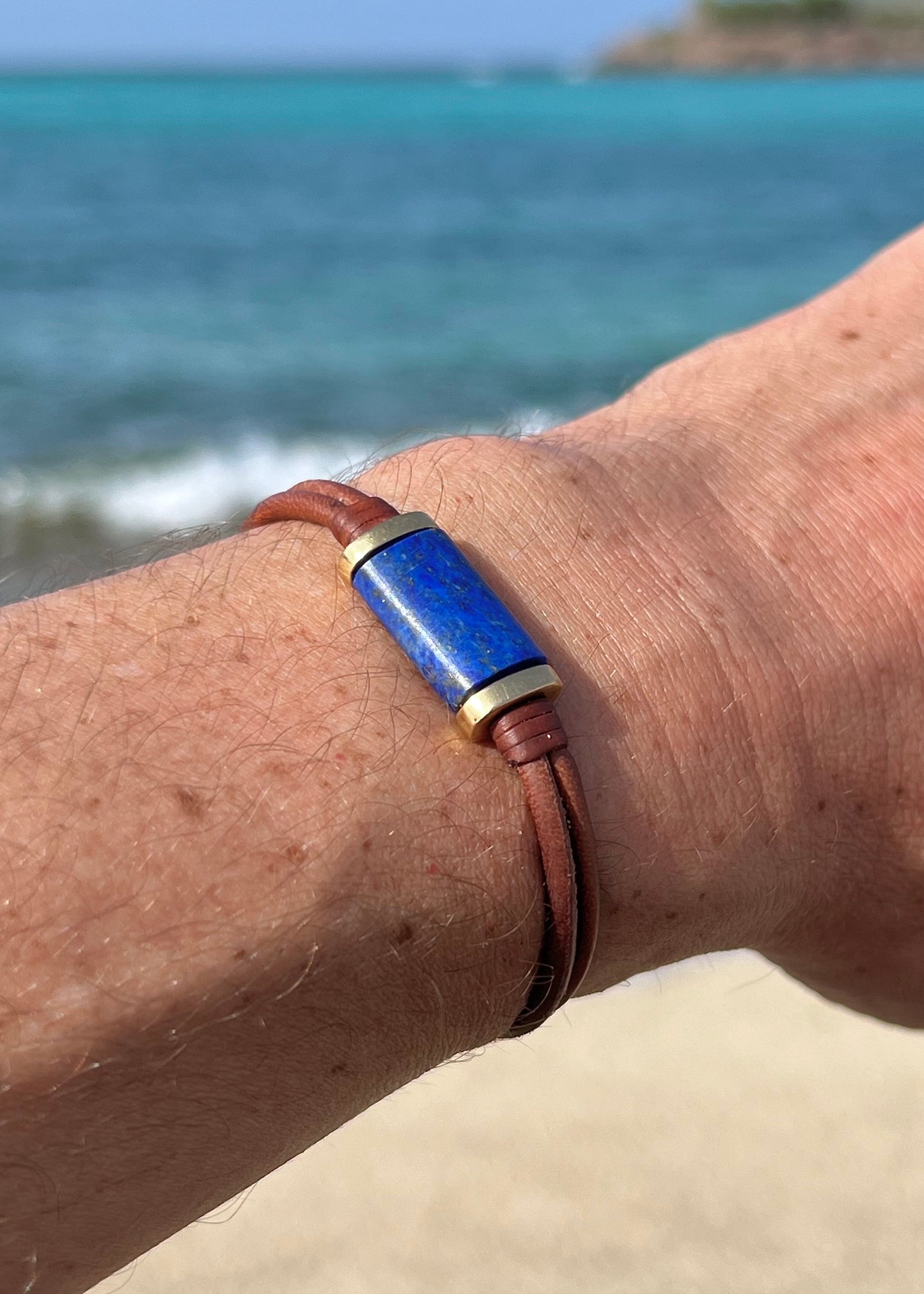 Afghan lapis lazuli gold leather bracelet worn on wrist, Caribbean turquoise sea