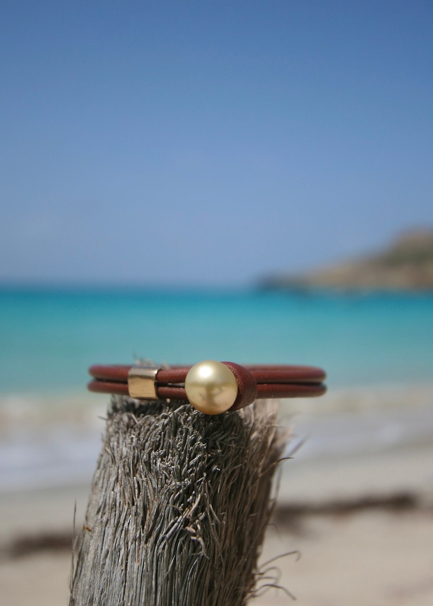 Hand sculpted 18K gold sliding bead with pearl on double strand rolled kangaroo leather on driftwood