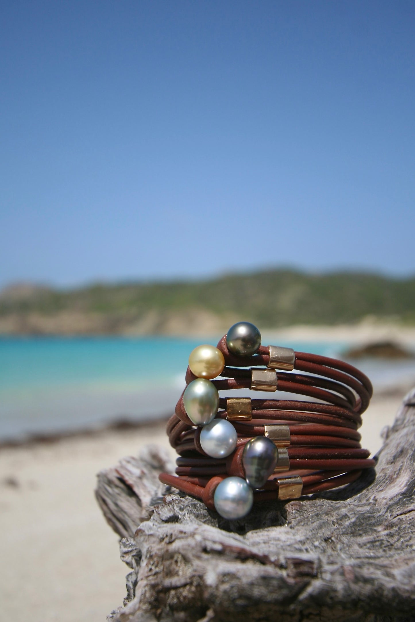 Trésors de St Barth 18K gold sliding bead bracelets stacked showing black gray white and golden pearl options