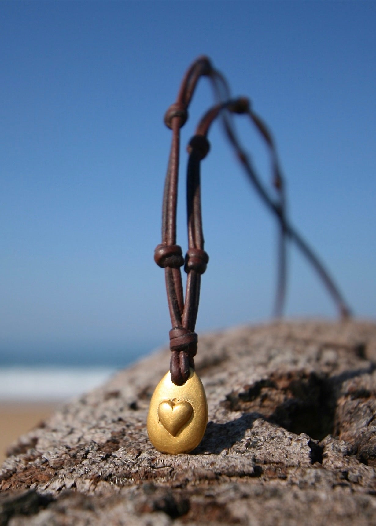 24K gold heart pendant necklace on leather cord, St Barth beach rock