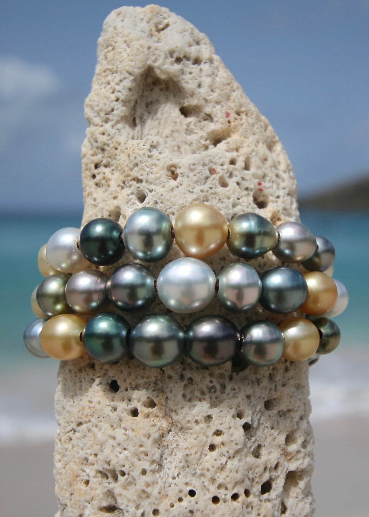 Trésors de St Barth multicolor pearl cuff on coral rock, Caribbean sea