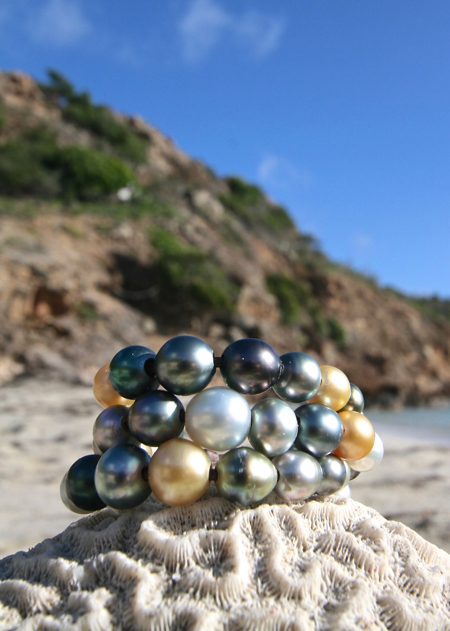 Tahitian pearl cluster cuff close-up on rock, St Barth coastline