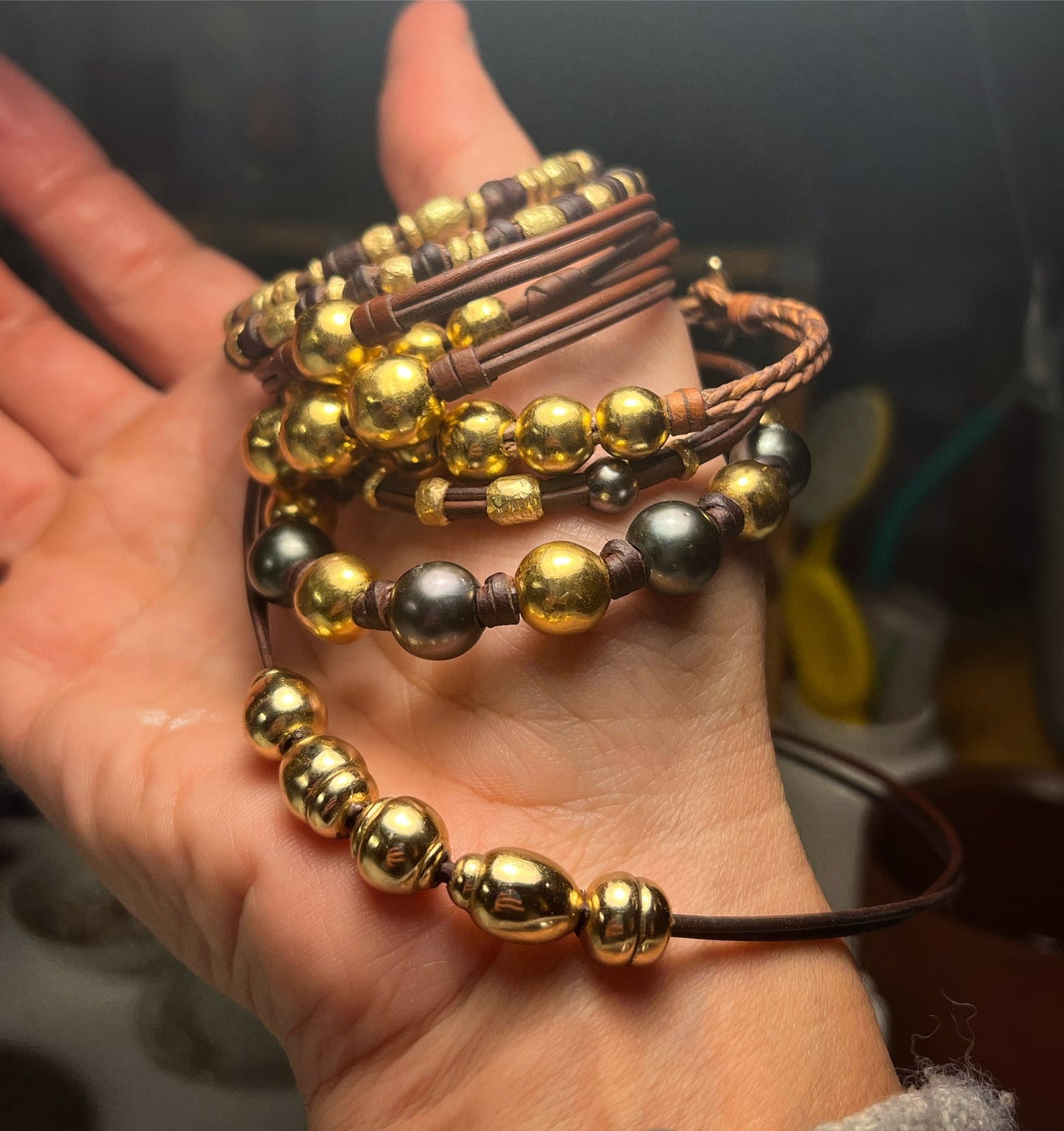 Handmade gold bead and leather bracelet collection, Trésors de St Barth workshop