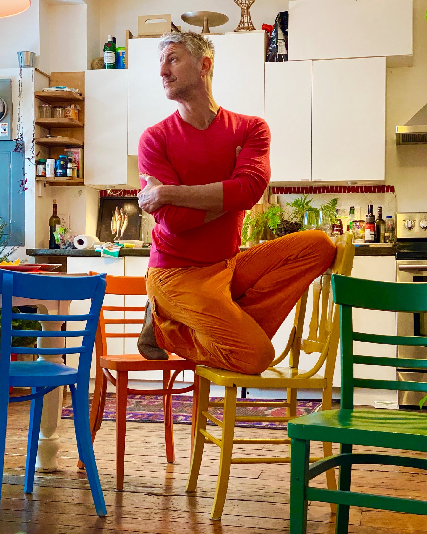 Ted Deltour in his kitchen studio, creative break surrounded by color