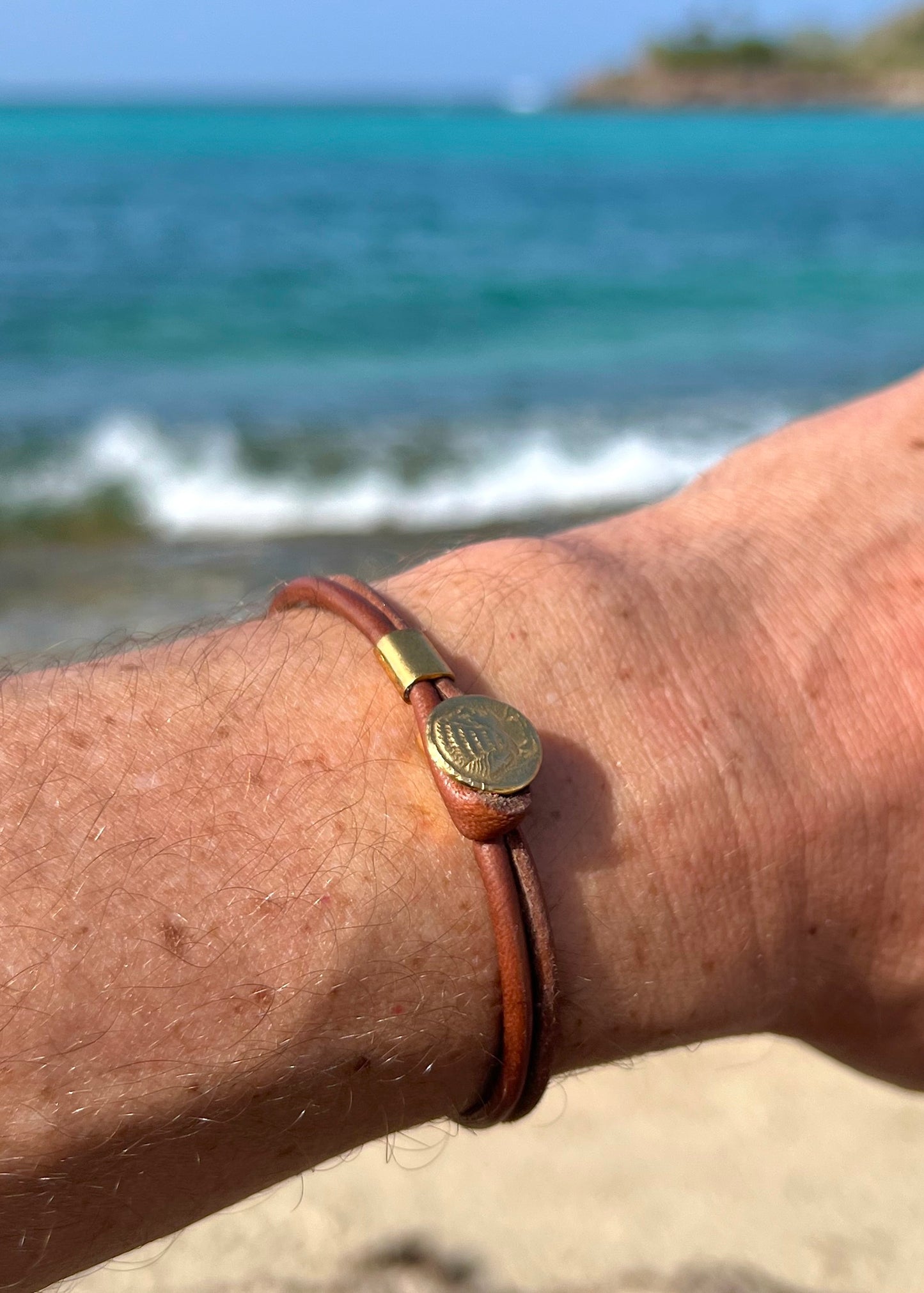 Ancient Greek coin bracelet worn on wrist, St Barth beach