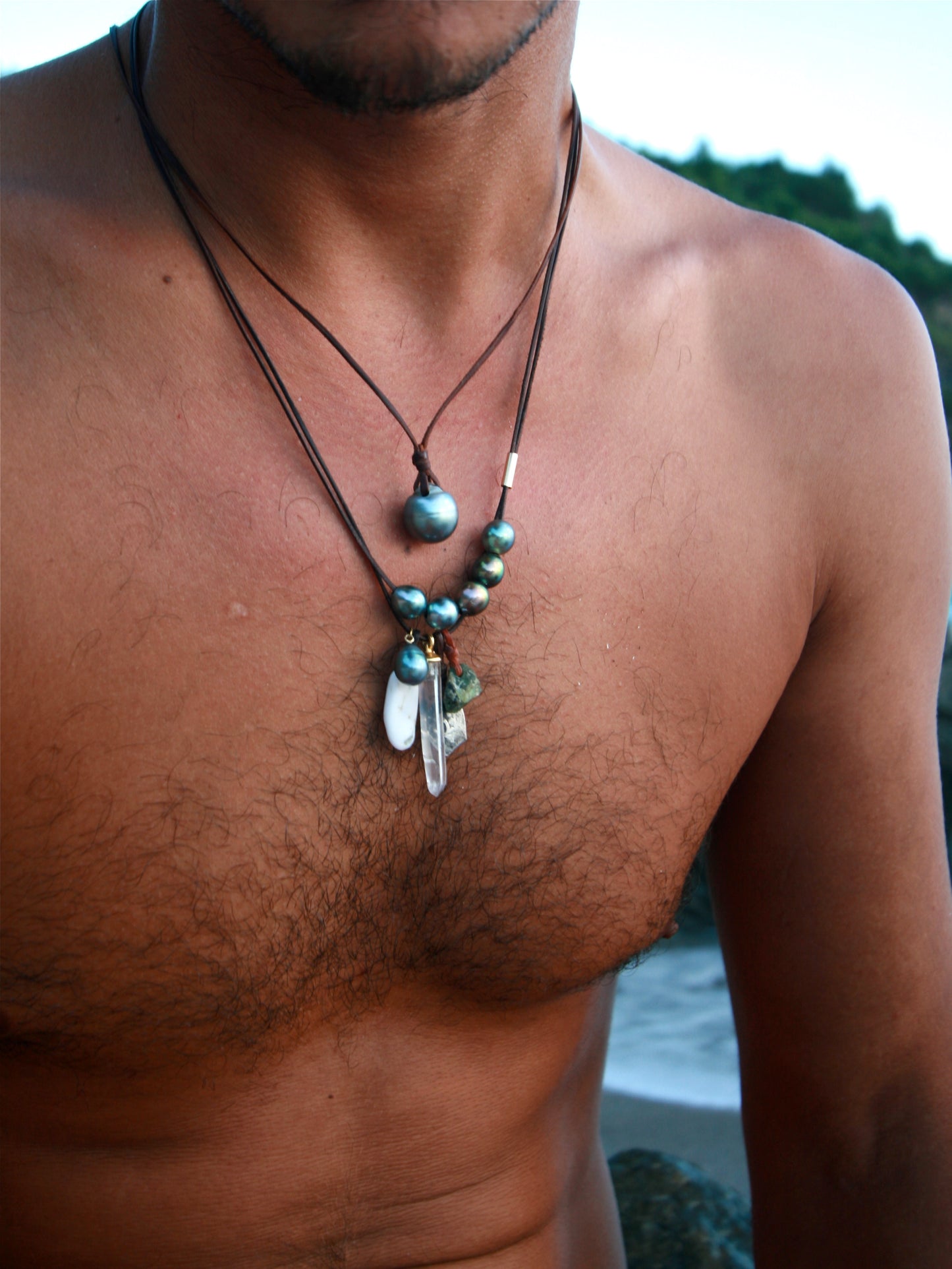 Tahitian pearl and rare stone necklace worn close to the skin st barth beach