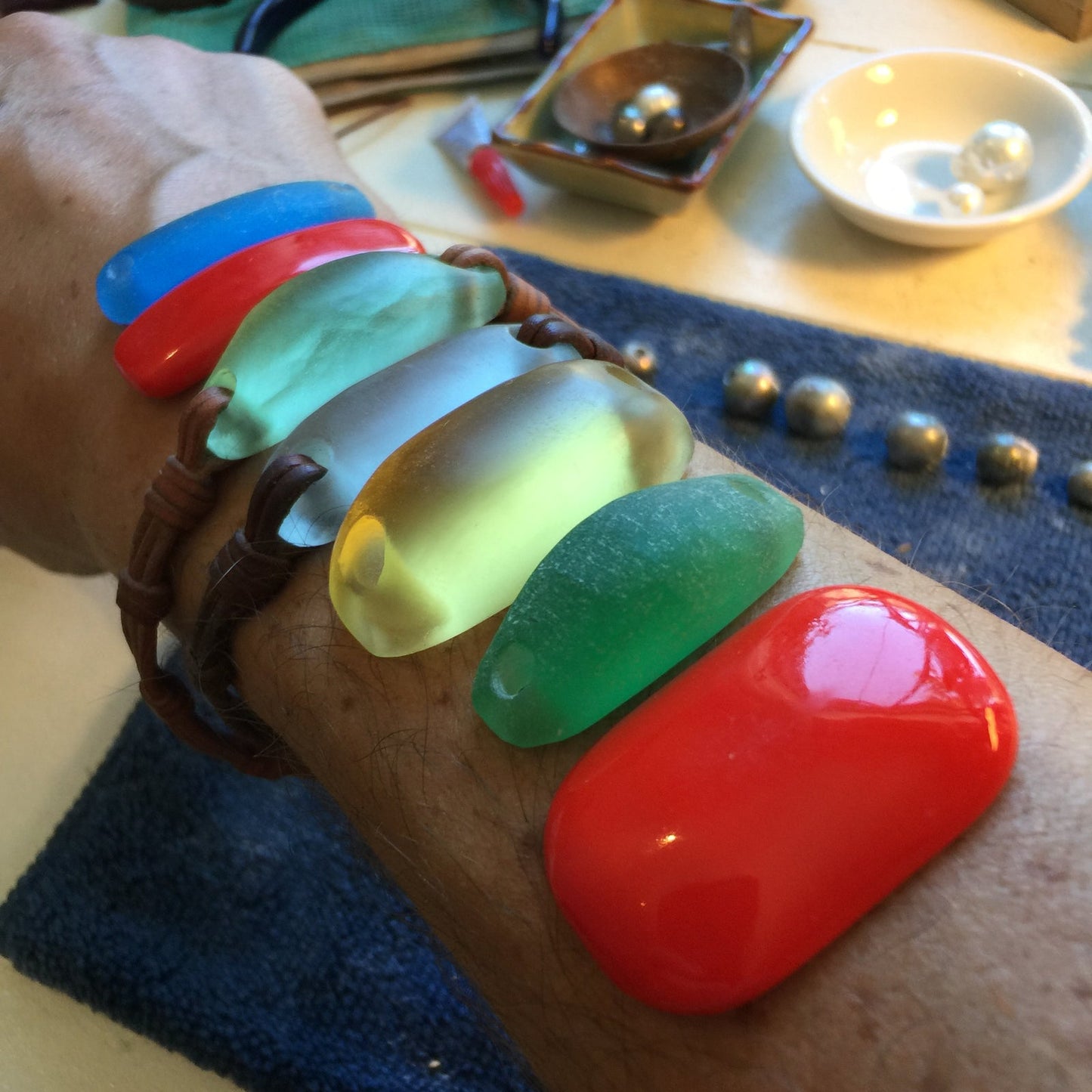 Multicolor crystal glass sea glass bracelet samples on wrist, workshop selection