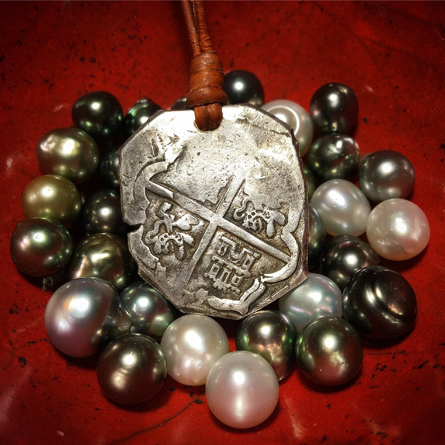 Pirate coin and Tahitian pearl collection on workbench, Trésors de St Barth