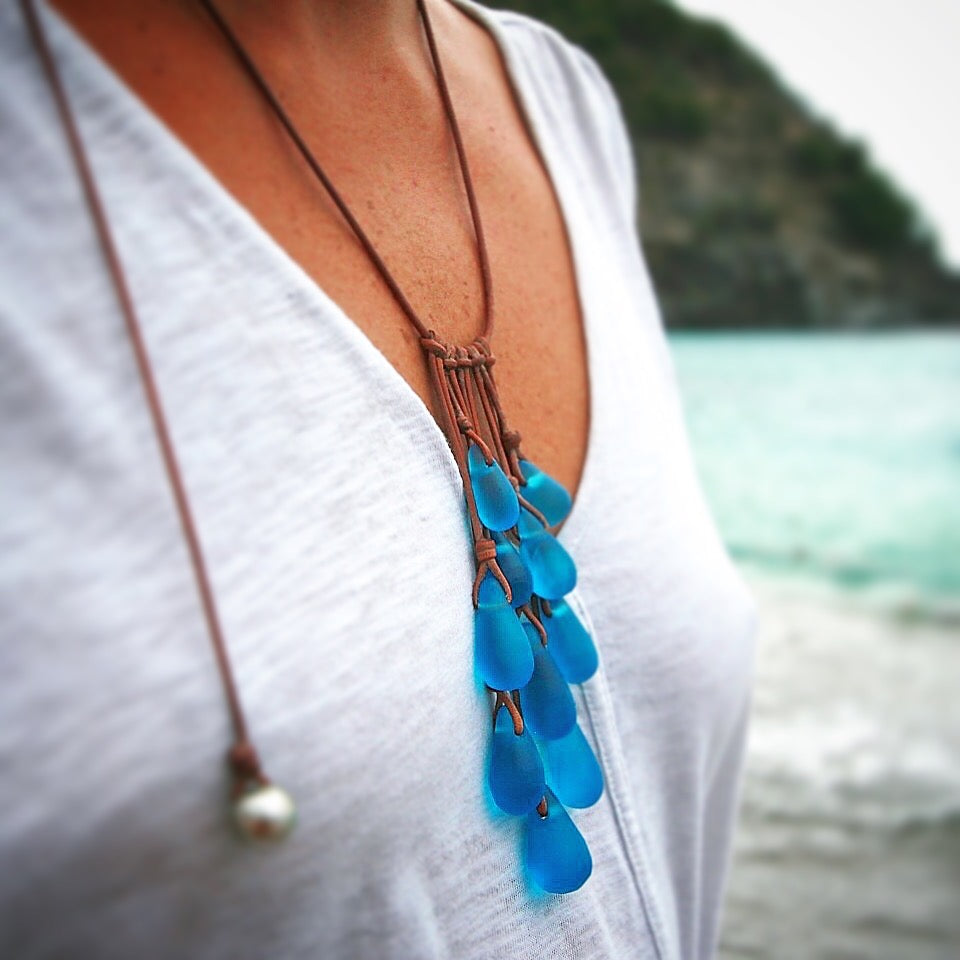 Long sea glass teardrop necklace on leather, worn over a white top st barth beach