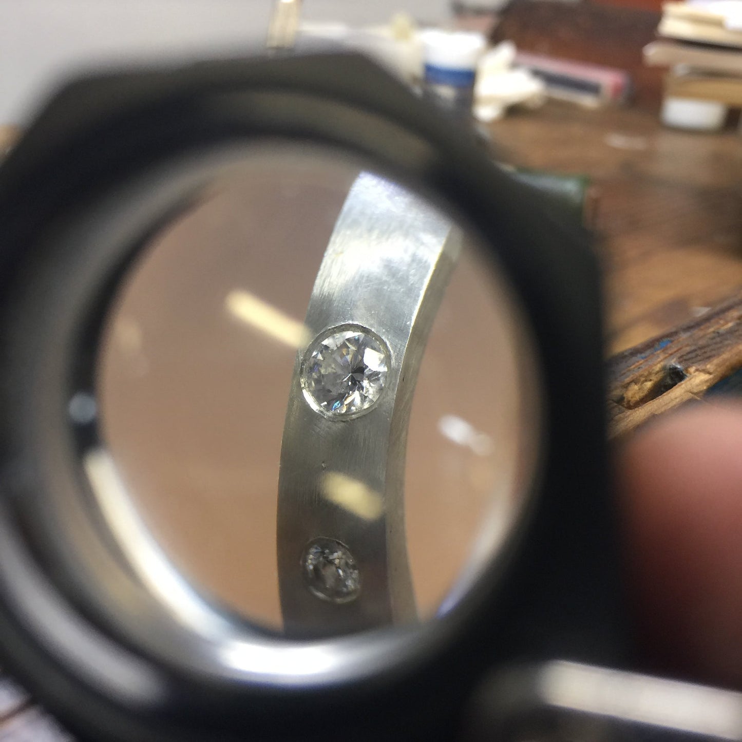 Diamond stone inspection through jeweler's loupe, Trésors de St Barth atelier