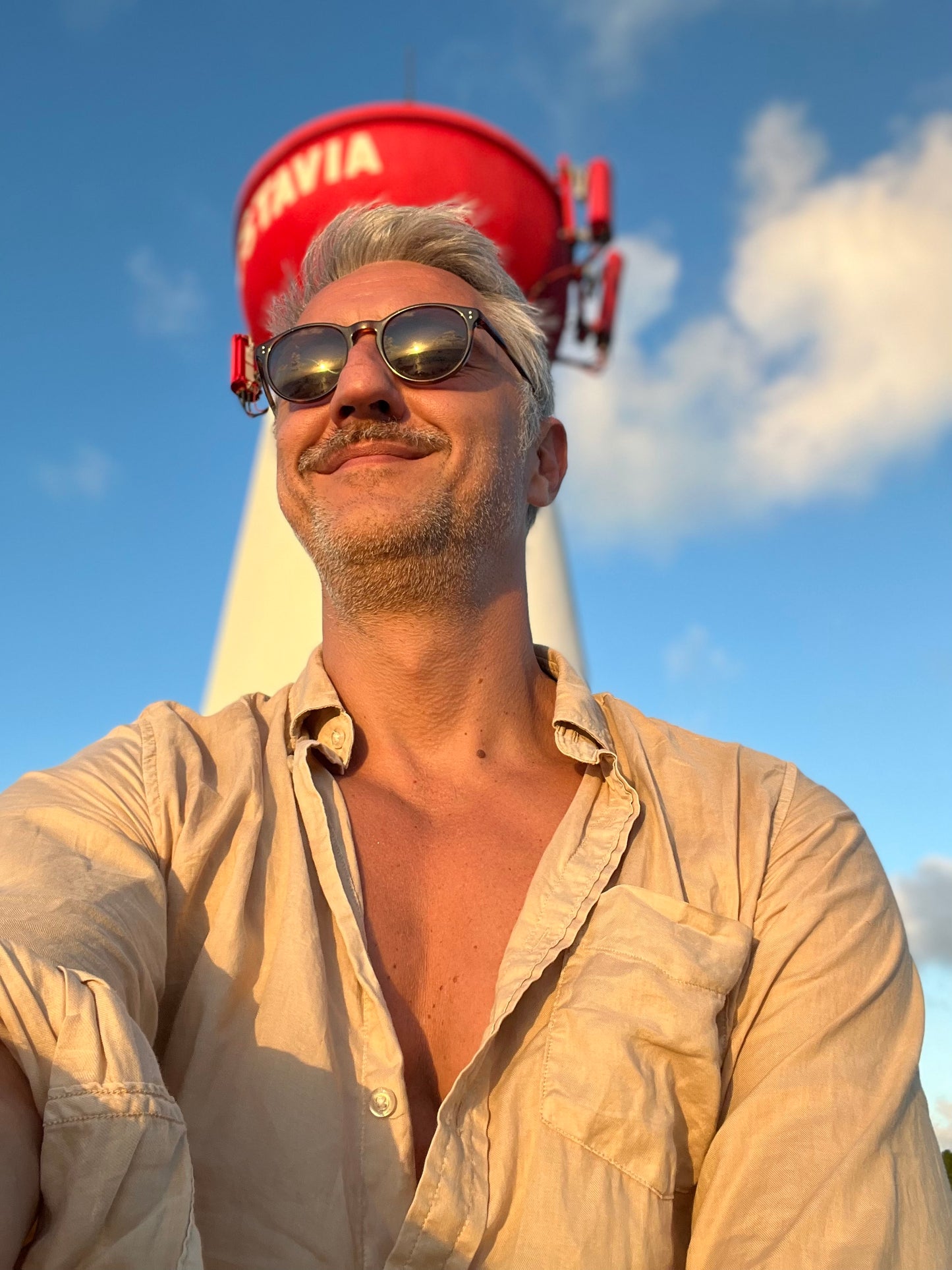Ted Deltour smiling under the St Barth Gustavia Lighthouse, sunny island mood