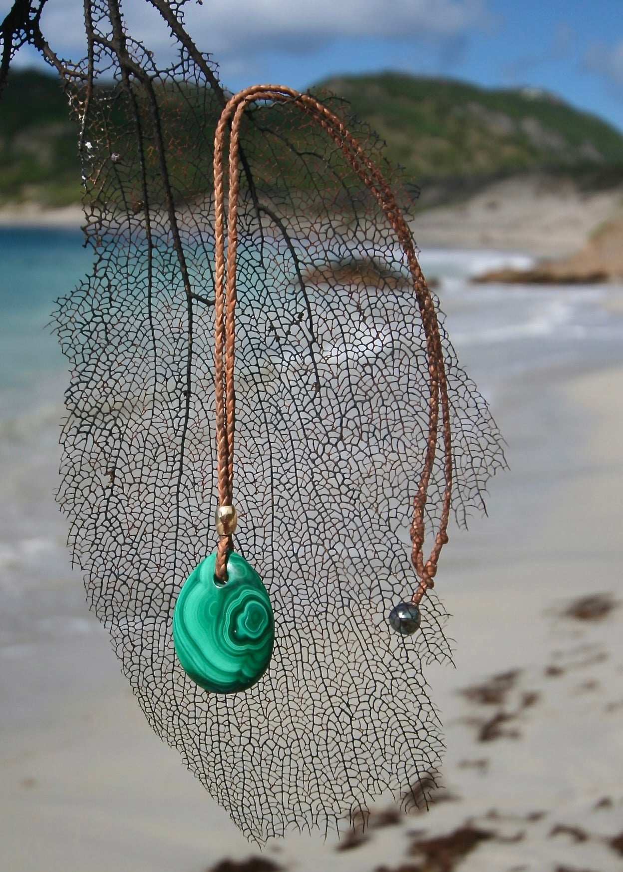 Trésors de St Barth malachite pendant leather necklace on sea net, Caribbean sea
