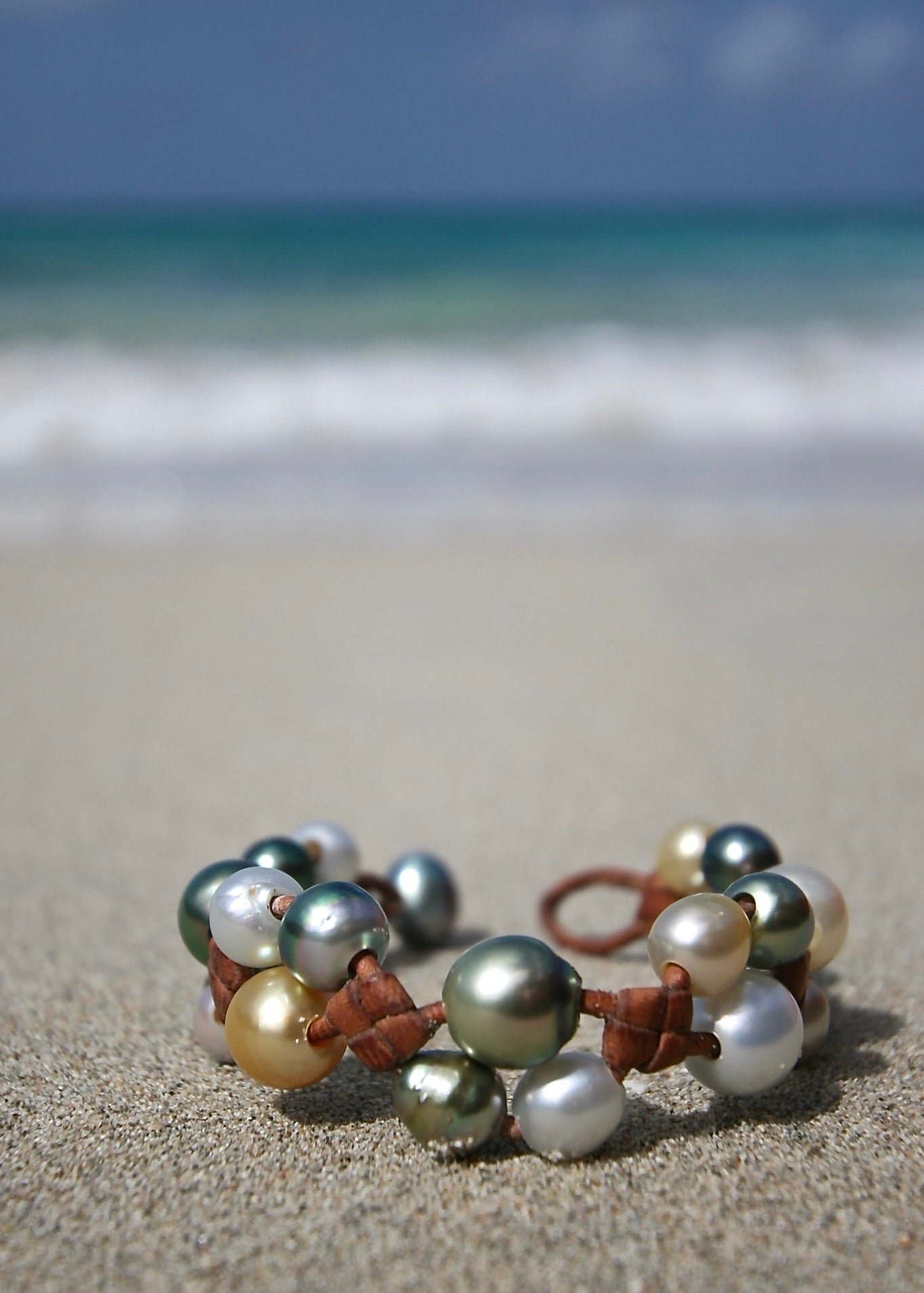 Tahitian and Australian pearl cluster bracelet close-up on driftwood, St Barth