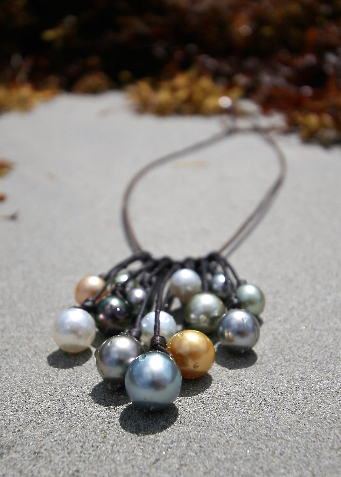 Trésors de St Barth pearl cascade leather necklace on sand, St Barth beach