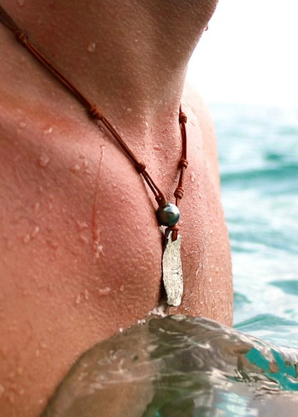 Trésors de St Barth pirate coin Tahitian pearl necklace worn on neck, St Barth