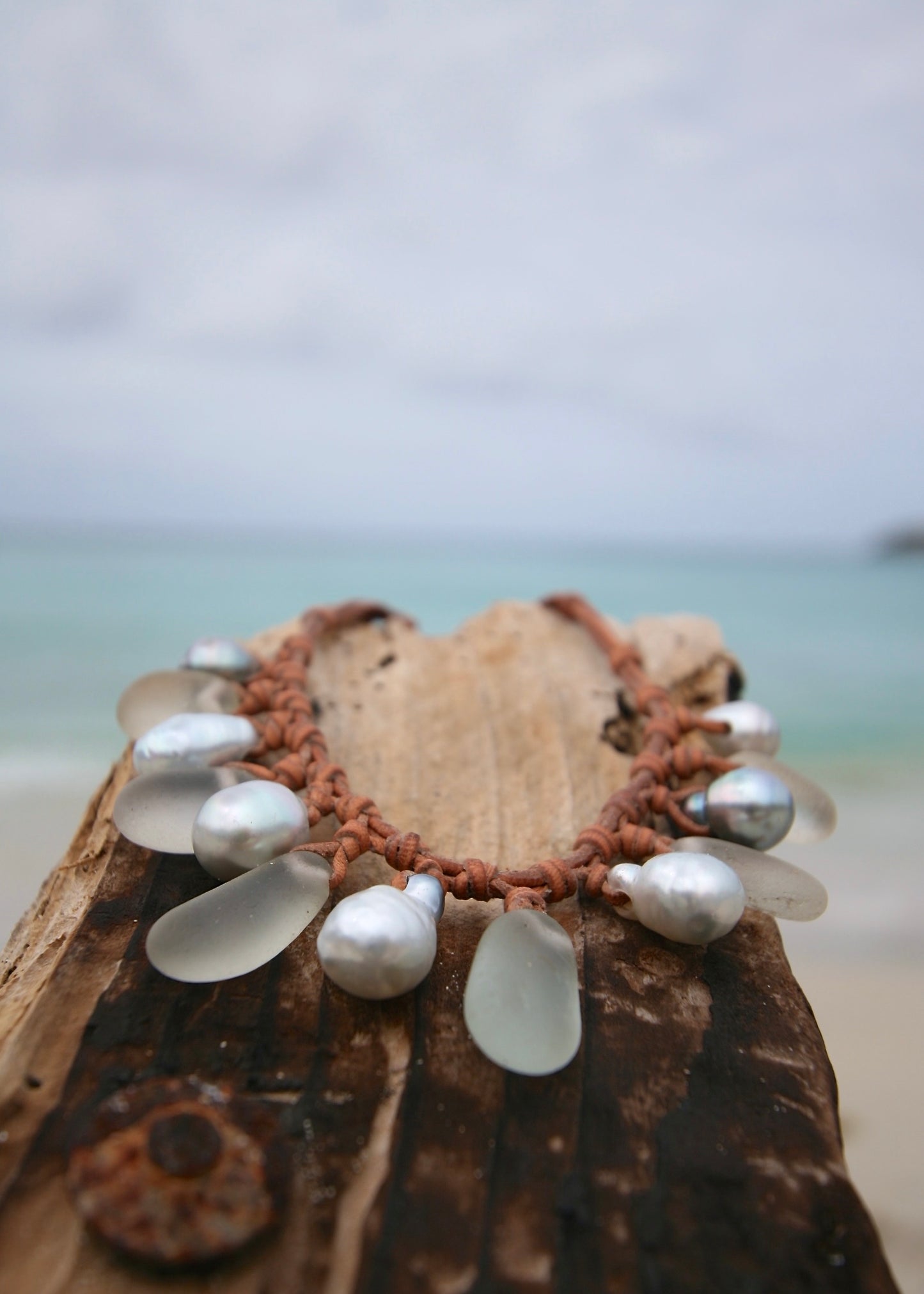 Genuine sea glass and pearl leather necklace on coconut, Caribbean sea