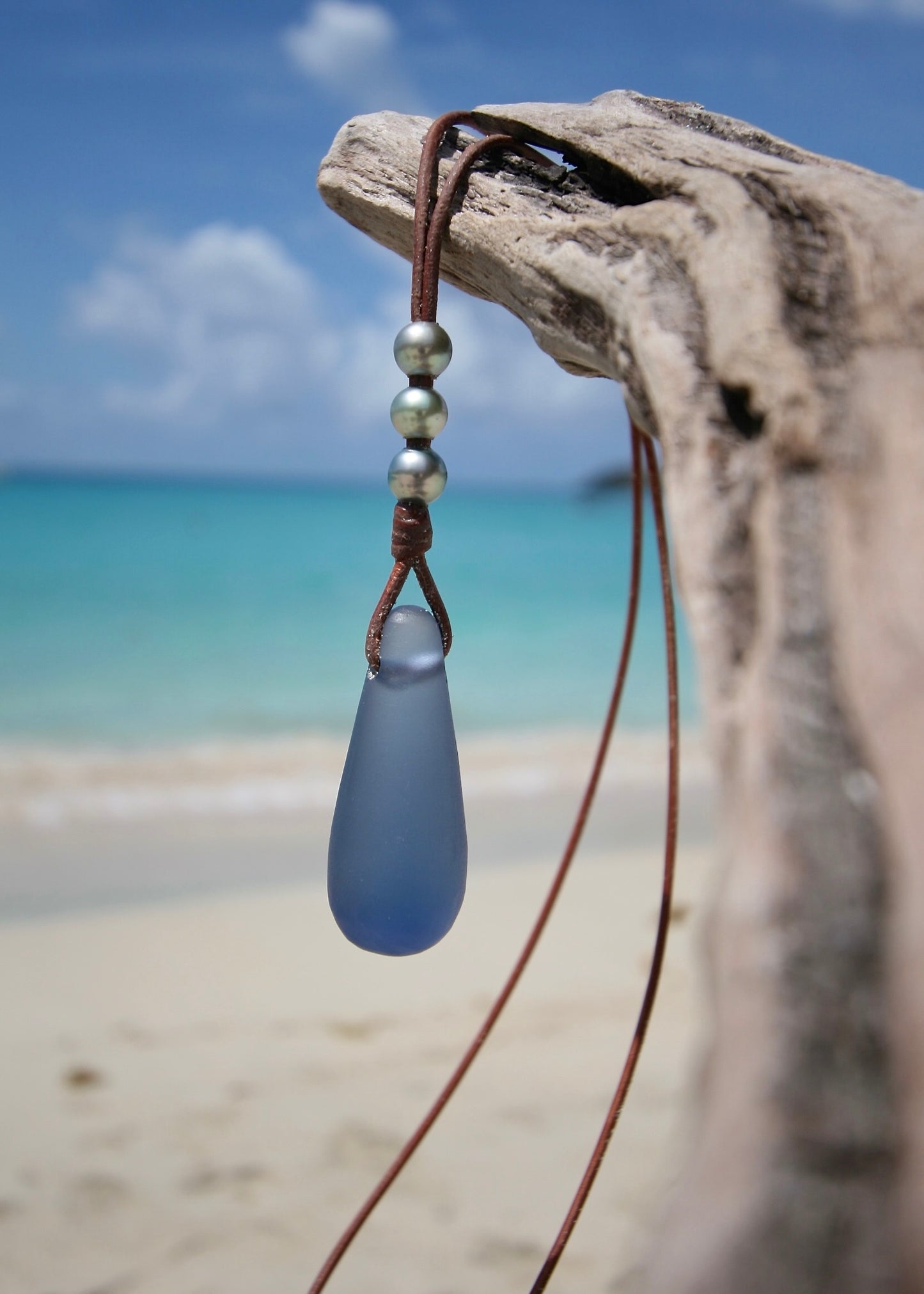 Blue crystal glass drop and Tahitian pearl necklace on leather, St Barth beach