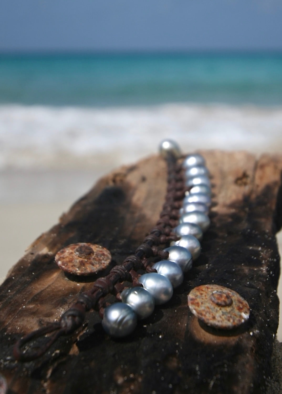 Trésors de St Barth Tahitian silver pearl charm bracelet on coconut, Caribbean sea