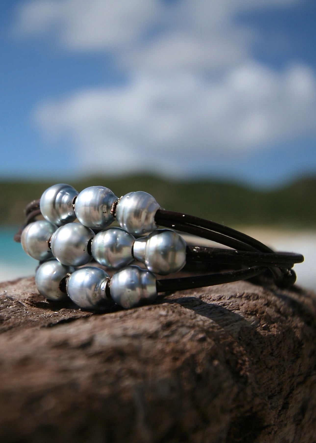 Tahitian pearl cluster triple wrap leather bracelet on wood, Caribbean sea