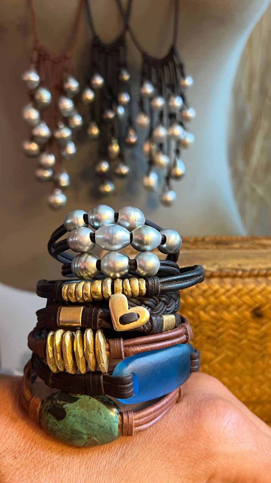 Stacked silver and gold bracelets with blue and green stone beads worn on wrist, one of a kind jewelry St Barth