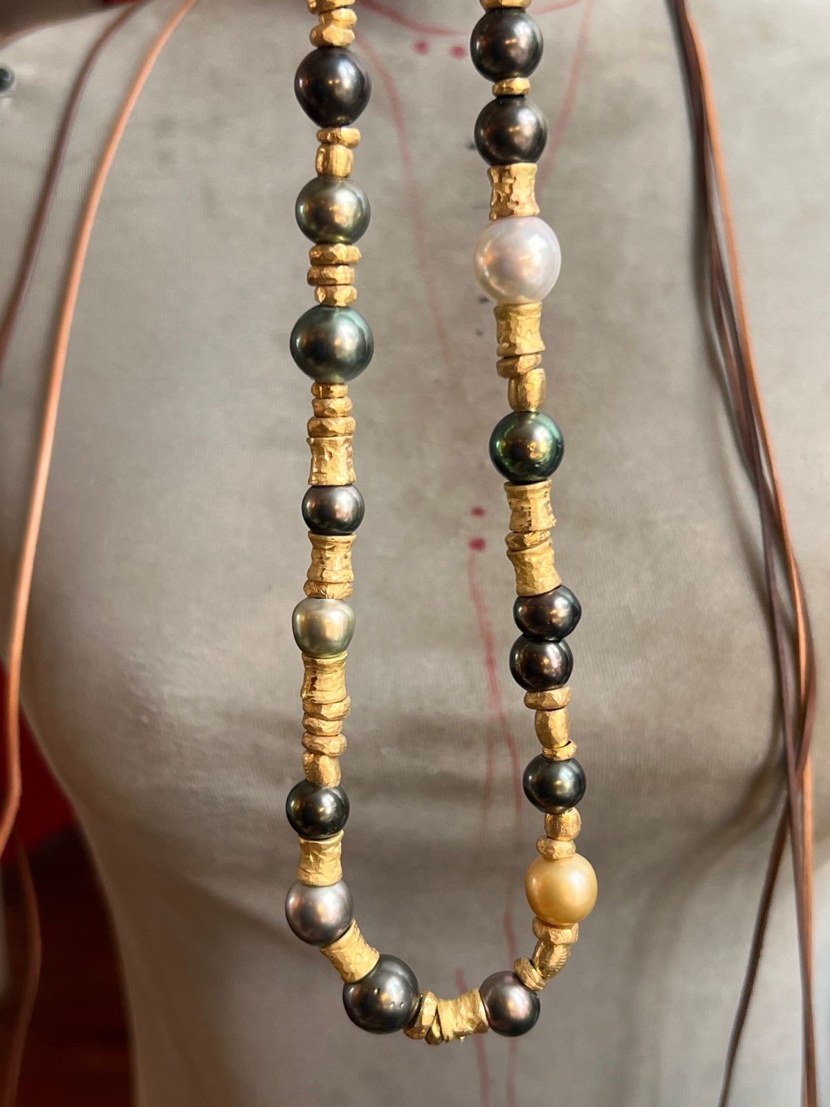 Tahitian pearl and gold beaded necklace worn on model, one of a kind jewelry St Barth