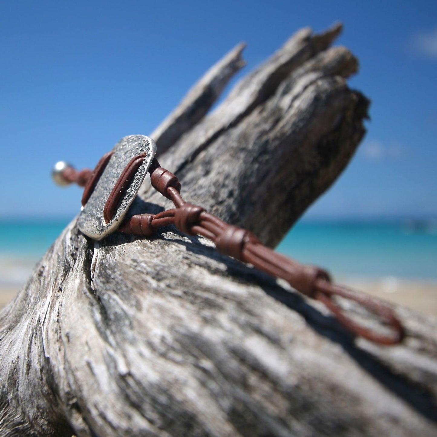 Hammered silver oval pendant on brown leather cord bracelet, one of a kind jewelry St Barth