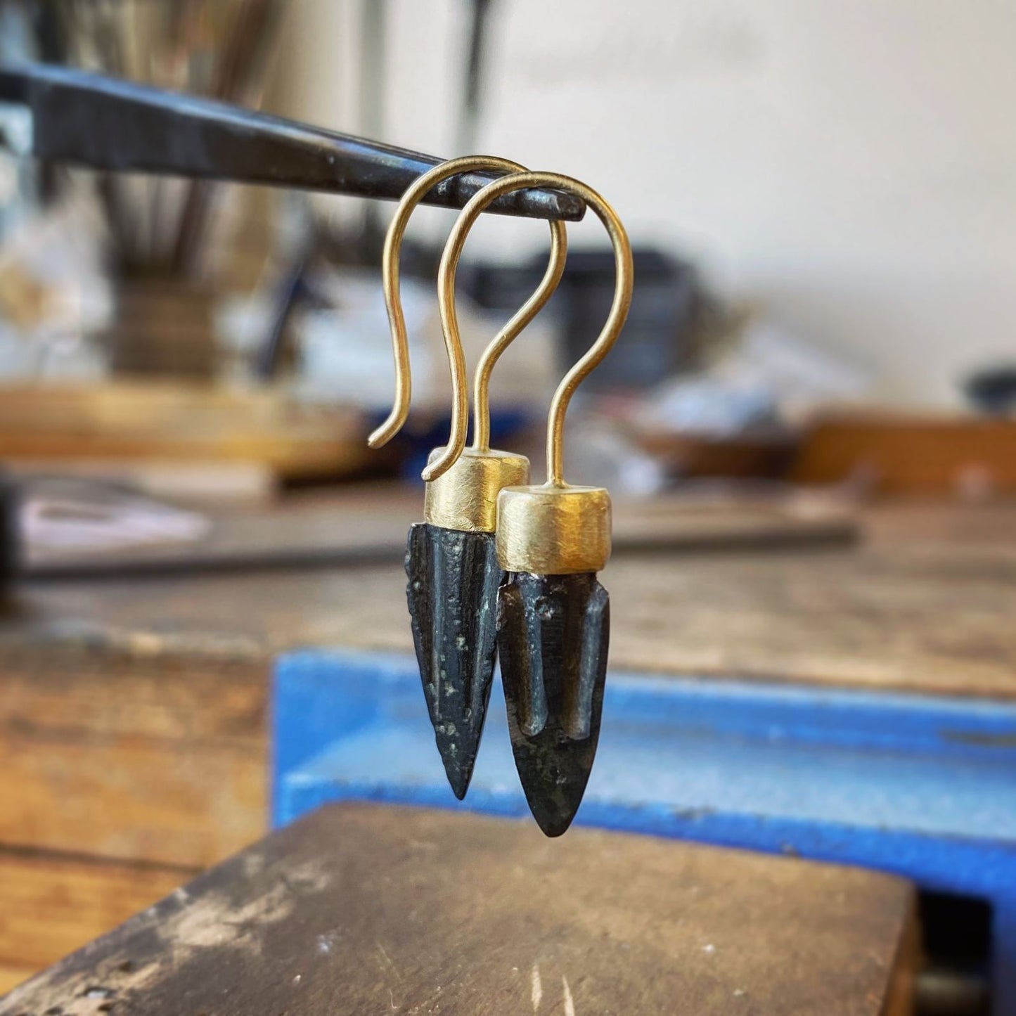 Onyx drop earrings with gold caps in jewelry workshop, one of a kind jewelry St Barth
