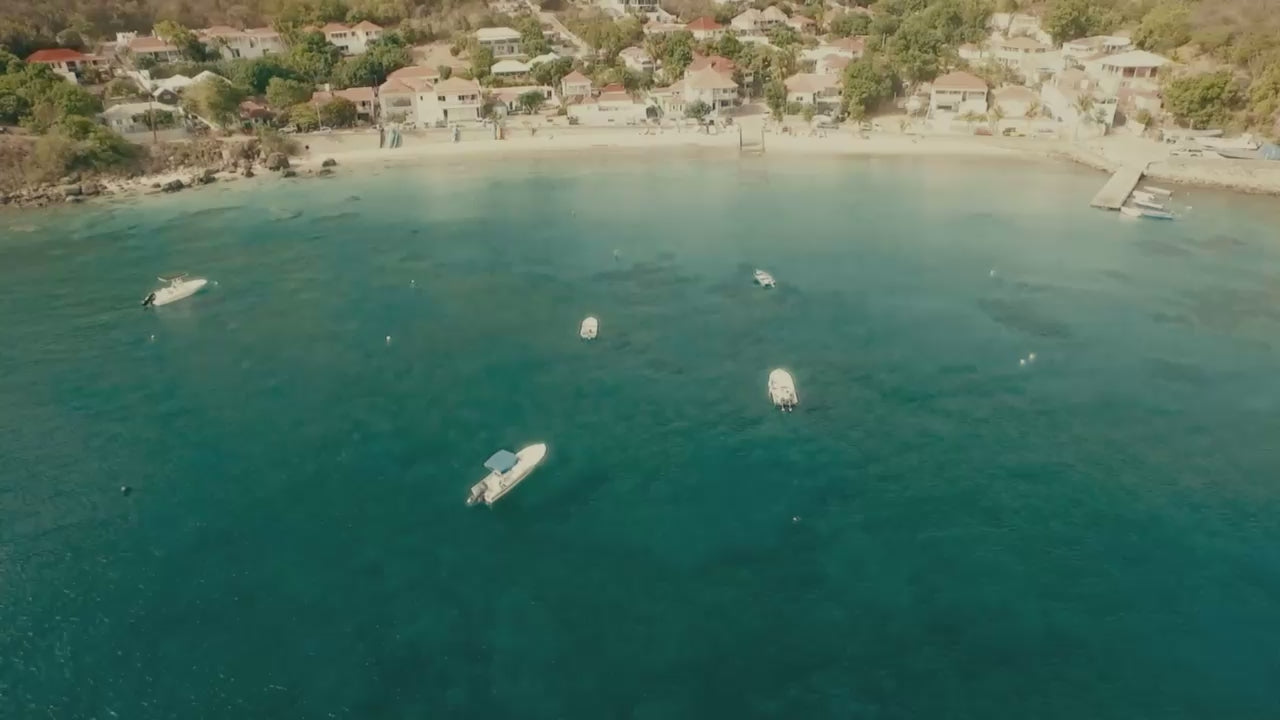 Aerial drone view of St Barth harbor, homepage video for Trésors de St Barth handmade Tahitian pearl and leather jewelry