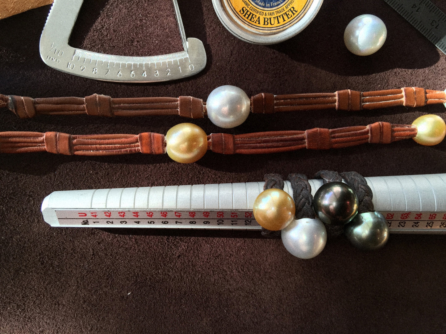 Pearl sizing tools, shea butter and kangaroo leather bracelets, jewelry care essentials
