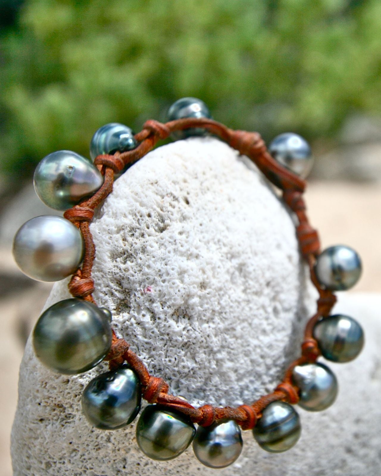 Tahitian pearl bracelet on leather cord displayed on coral rock, one of a kind jewelry St Barth