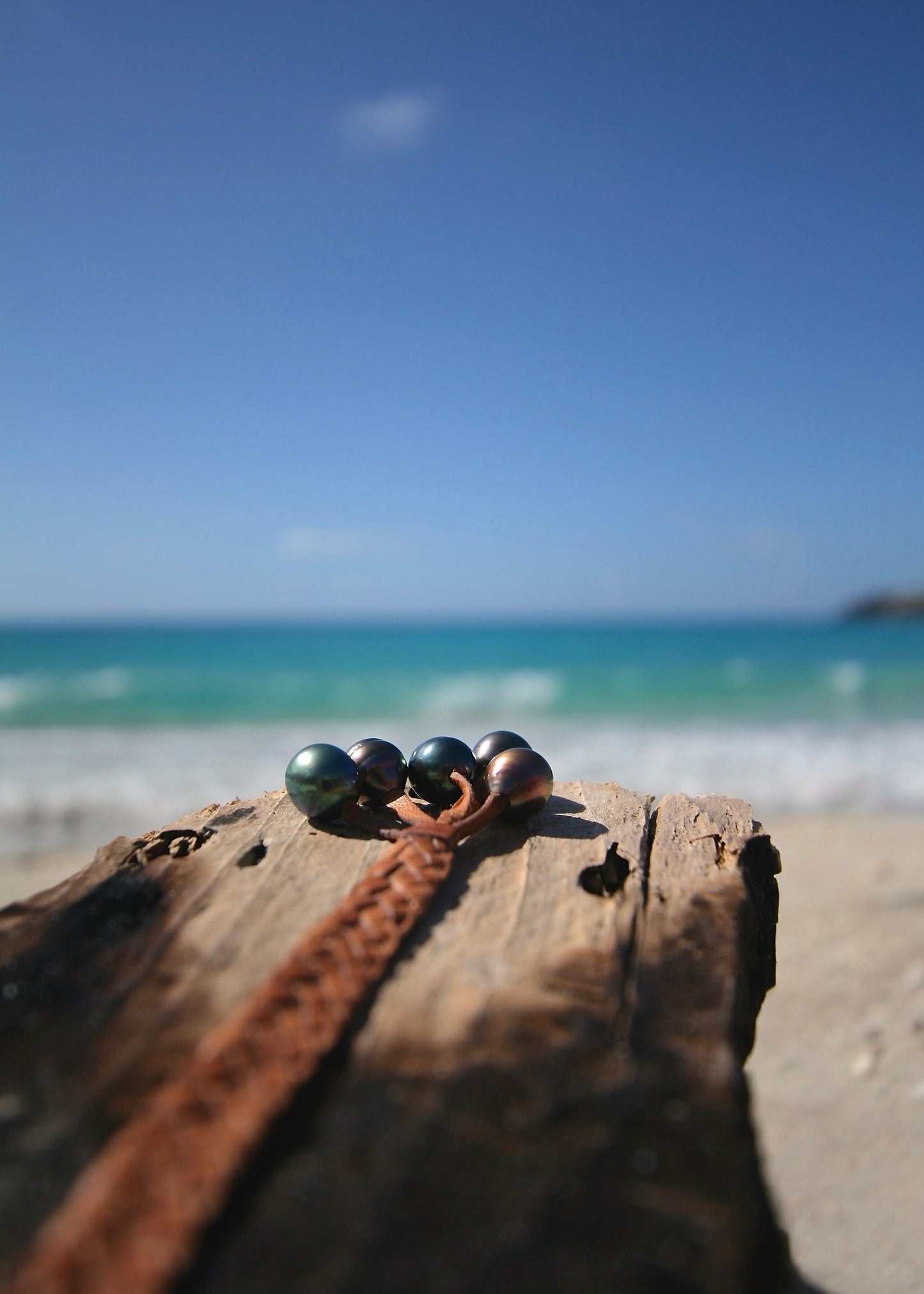 Trésors de St Barth Tahitian pearl braided bracelet on kangaroo leather with pearl clasp on driftwood