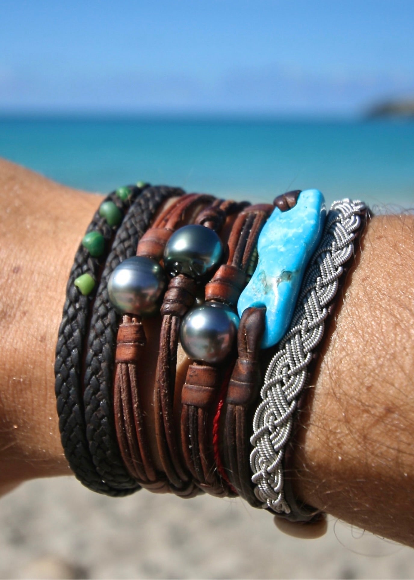 Trésors de St Barth Tahitian pearl minimalist bracelet stacked with other leather bracelets on wrist
