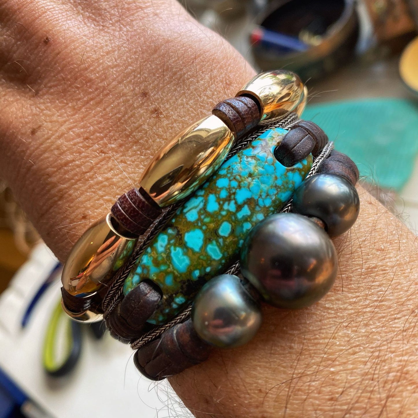 Turquoise bangle bracelet stacked with pearl beads worn on wrist, one of a kind jewelry St Barth