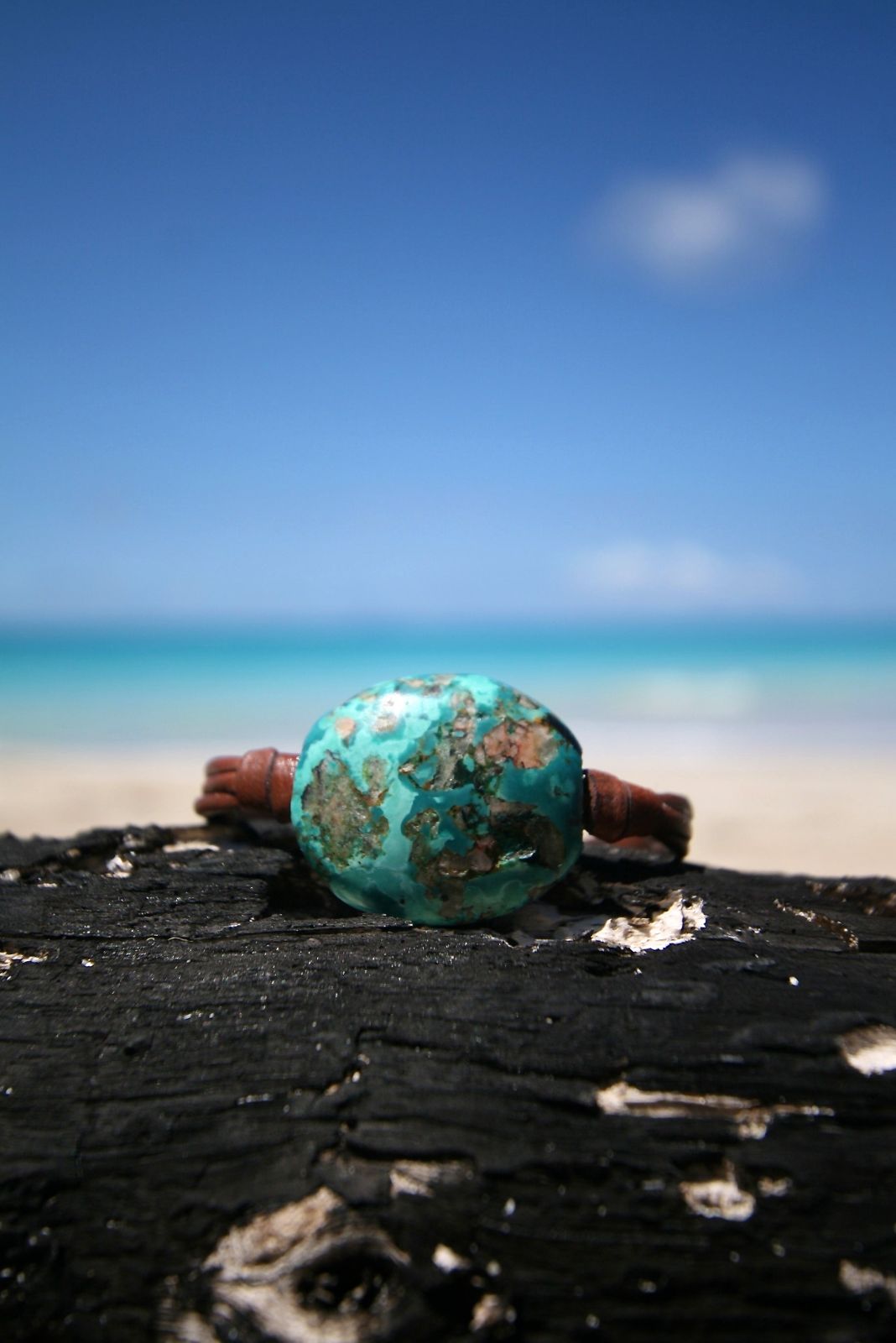 Turquoise bead bracelet on leather cord resting on driftwood, one of a kind jewelry St Barth